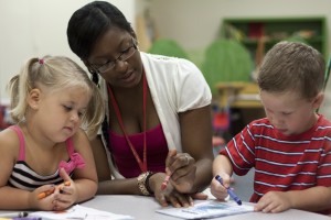 UA student working with two young children