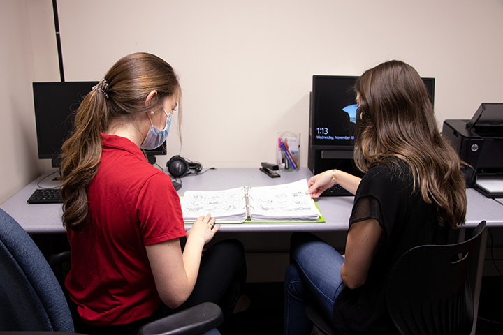 graduate students studying a procedure manual